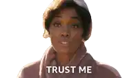 a woman wearing a turban and a coat says " trust me "