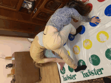 two people are playing a game of twister on a white sheet