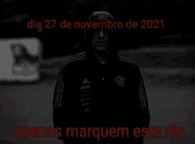 a black and white photo of a man standing in the rain with the words dia 27 de novembro de 2021 apenas marquem este dia