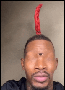 a man with a red object on top of his head