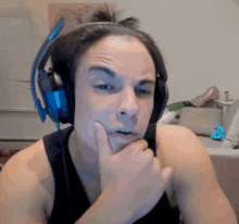 a man wearing headphones and a black tank top