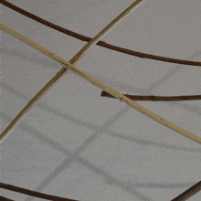 a bunch of wooden sticks are hanging from a ceiling