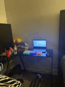 a laptop sits on a desk with a keyboard and mouse