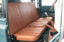 the back seat of a car with brown leather seats