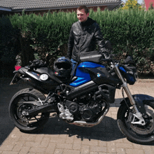 a man stands next to a bmw motorcycle