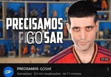 a man in a red shirt is making a funny face in front of a shelf of figurines .