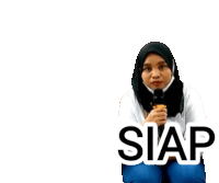 a woman in a hijab is kneeling down with a microphone in her hand and the word siap written on the bottom .