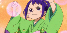 a little girl with purple hair is smiling and wearing a green dress