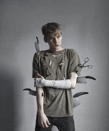 a young man with knives and scissors coming out of his arms