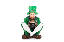 a man dressed as a leprechaun is holding a pot of gold .