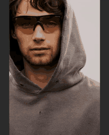 a close up of a man wearing a hoodie and sunglasses that says smith & wesson