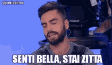 a man with a beard is making a funny face and saying senti bella stai zitta