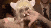 a woman in a cat costume is making a face with her hands