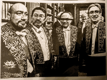 a black and white photo of a group of men in fancy jackets