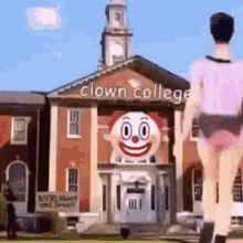 a man is running in front of a clown college building .