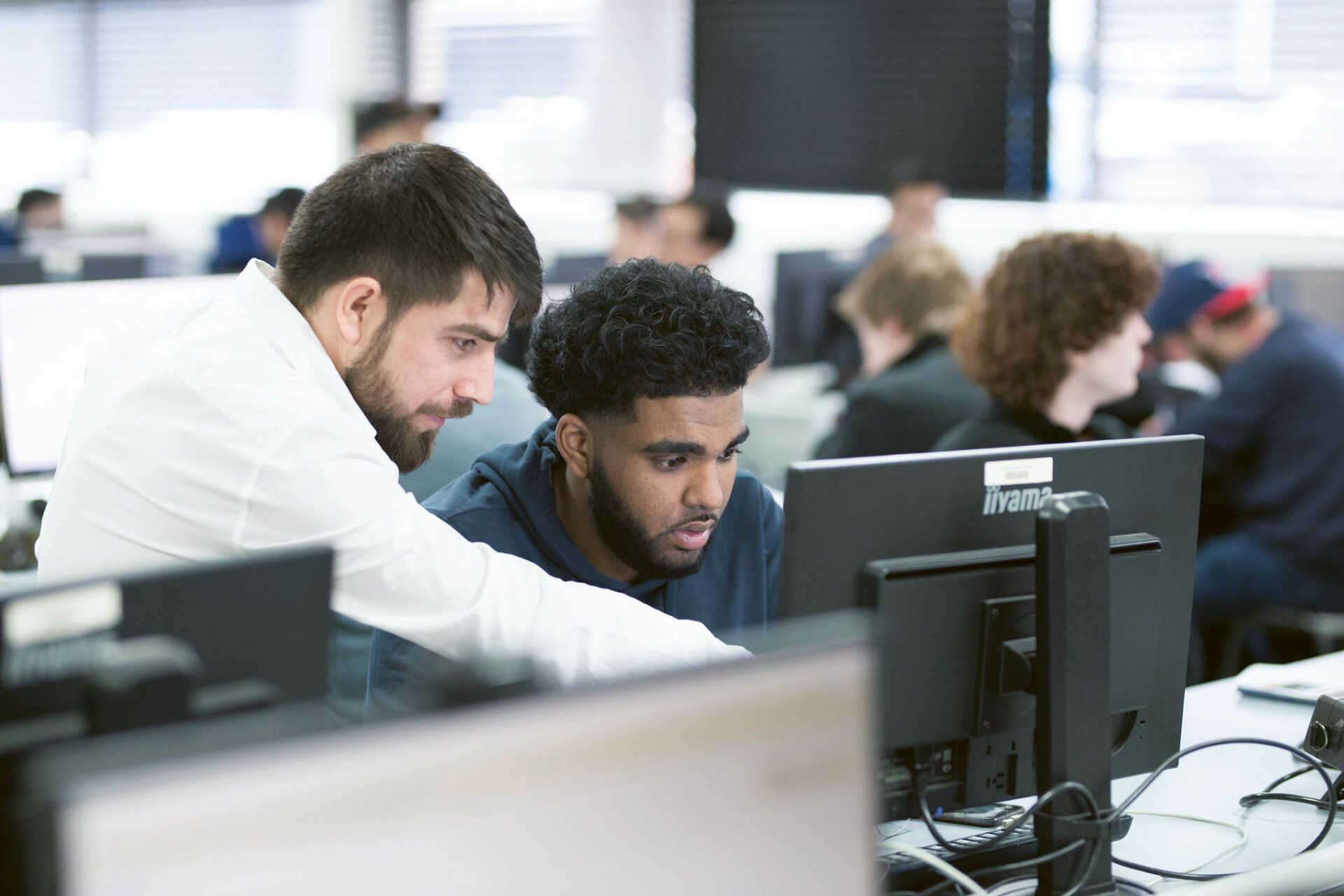 Mixed group of students sitting at computers