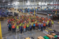 Workers pose at the new Aristocrat Gaming facility.
