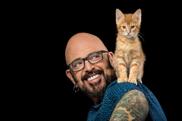 Jackson Galaxy smiles at orange kitten on his shoulder