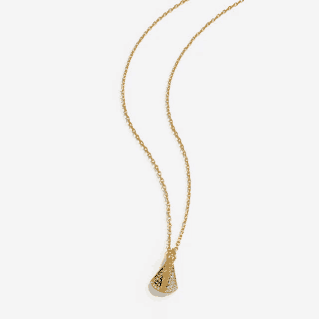 a gold necklace with a blue pendant on a white background