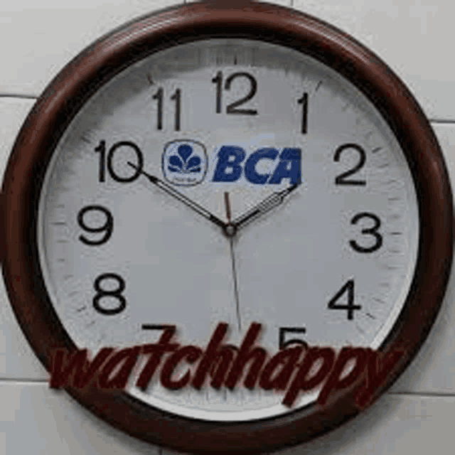 a clock with the word watchhappy on it is on a wall .