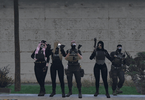 a group of people standing in front of a wall with one wearing a police shirt