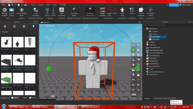 a computer screen shows a model of a person wearing a santa hat in a box