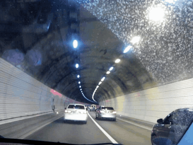 a car is driving down a highway in a tunnel with a license plate that says lg