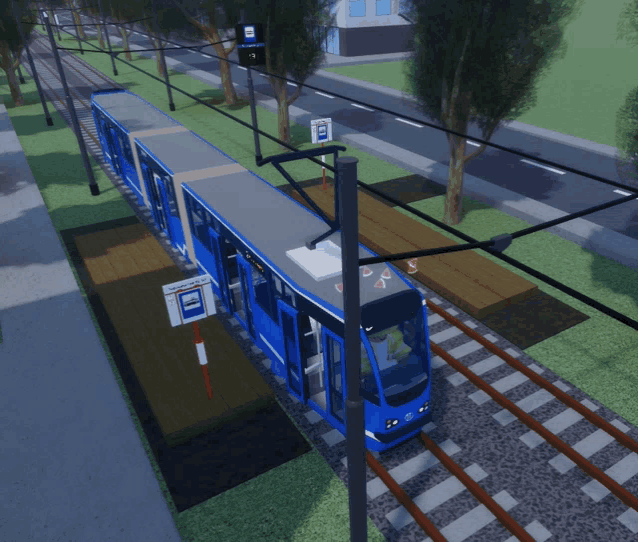 a blue train is going down the tracks near a sign that says " trolley "