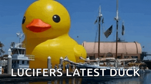 a large yellow rubber duck with the words " lucifer 's latest duck " above it