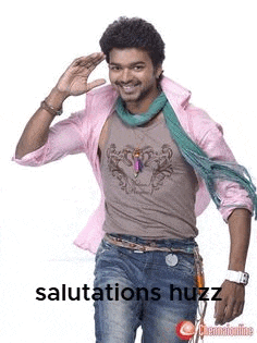 a man in a pink shirt and scarf is saluting with his hand .