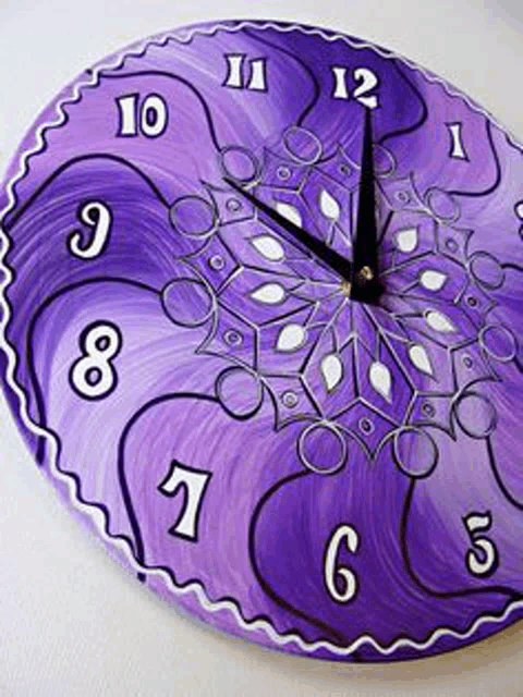 a purple clock with white numbers and a purple design on it .