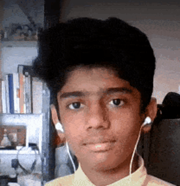 a young boy wearing headphones and a yellow shirt