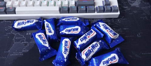 a bunch of milky way candy wrappers on a table