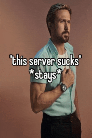 a man with a beard is standing in front of a sign that says this server sucks * stays *