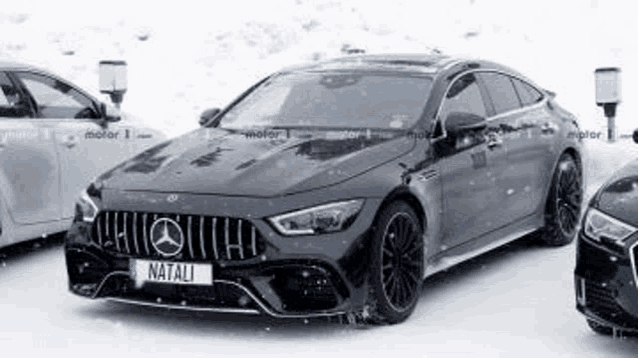 a mercedes amg gt 63 s coupe is parked in the snow next to a mercedes a class .