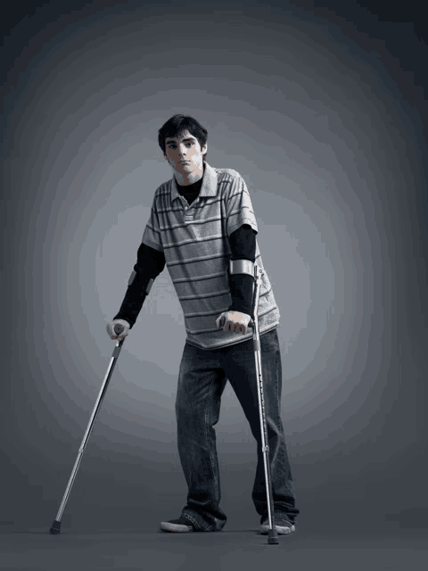 a young man with crutches is wearing a grey striped shirt