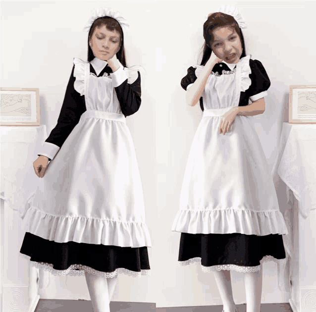 a girl in a maid costume is standing next to another girl