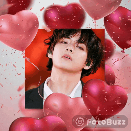 a picture of a man surrounded by heart shaped balloons and confetti with the words fotobuzz below it