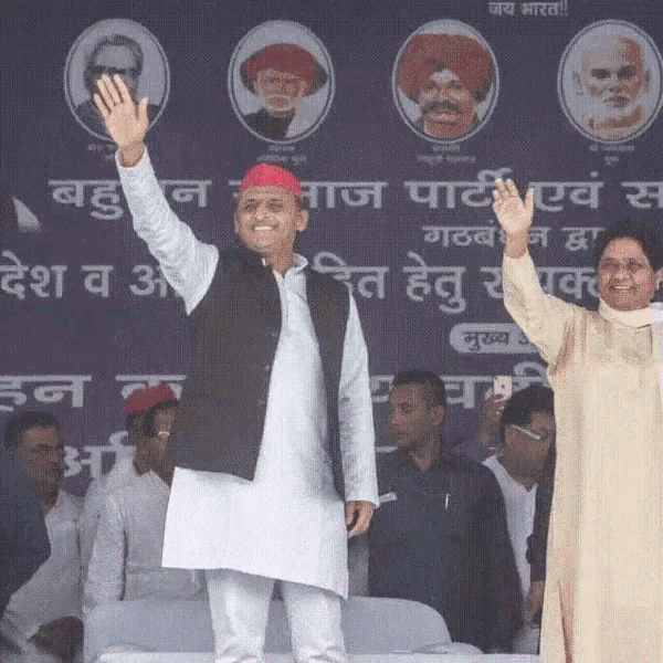 a man in a red turban is waving his hand in front of a sign that says ' aaj party '