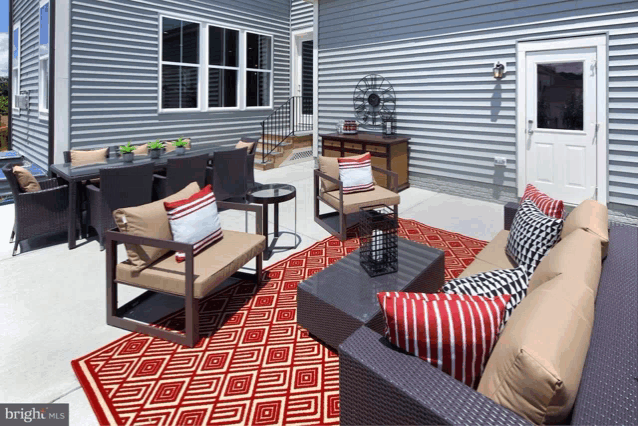 a patio with a couch and chairs and a rug that says bright homes