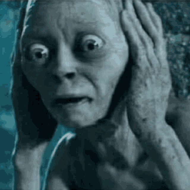 gollum from the lord of the rings is holding his hands to his face .