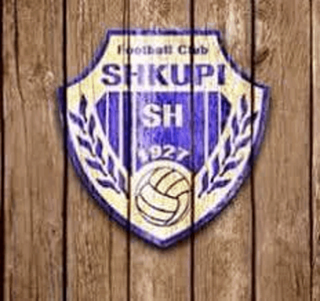 a shield with a soccer ball and laurel leaves on a wooden wall .