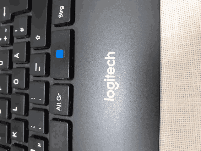 a close up of a logitech keyboard showing the alt key