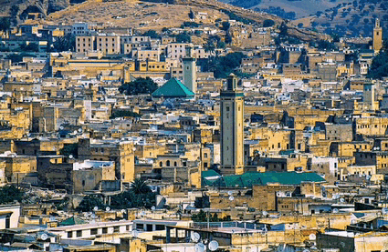 an aerial view of a city with a clock tower in the center