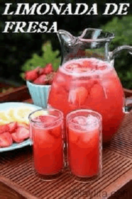 a pitcher and two glasses of strawberry lemonade are on a table .