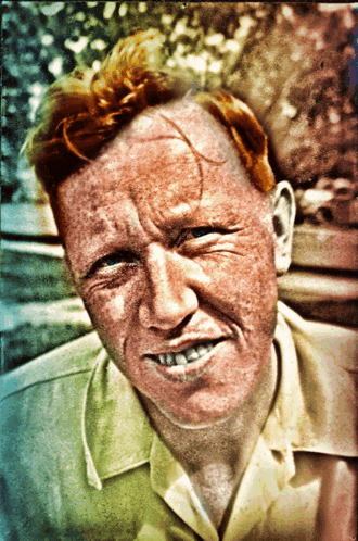 a man with red hair and freckles is smiling and looking at the camera