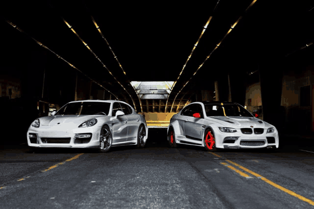 a porsche and a bmw are parked side by side