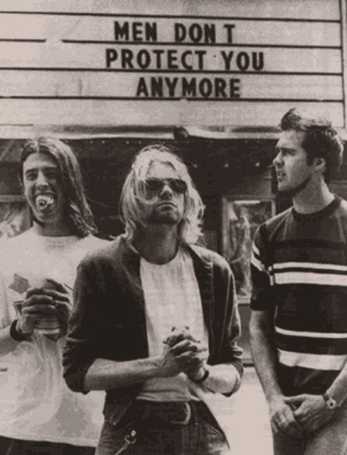 three men are standing in front of a sign that says men don t protect you anymore