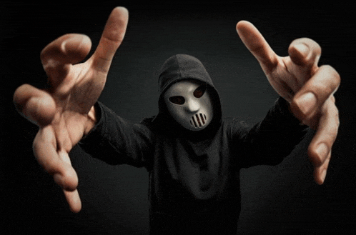 a man wearing a white mask and a black hoodie reaches out his arms