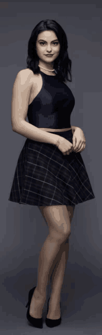 a woman in a blue halter top and plaid skirt